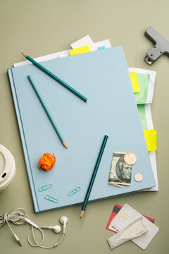 Back to school concept with scattered objects on blue notebook