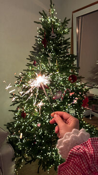 Sparkler by Christmas Tree