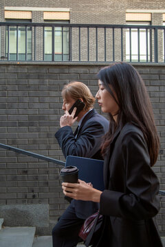 Business professionals walking outdoors during work break