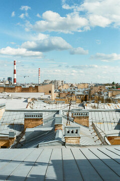 City Rooftops Under a Blue Sky With Clouds