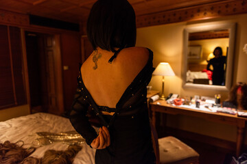 Woman adjusting dress in bedroom. © Rawpixel.com