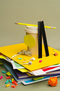 Stack of colorful stationery and coffee cups in a lo-fi setup