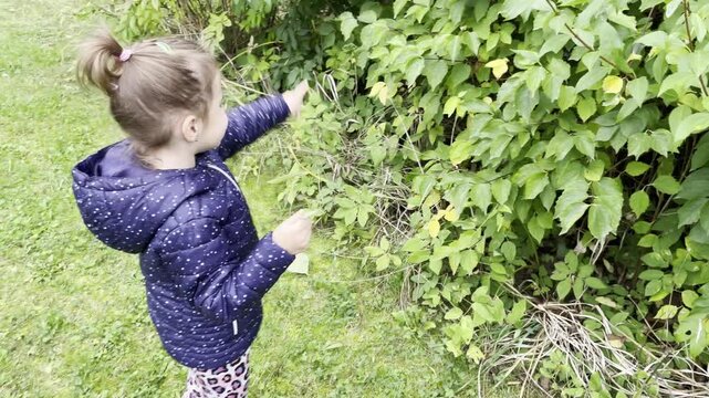 Little girl having fun, acting goofy and playing outdoors