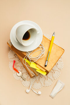 Empty coffee mug on stack of books over vintage crochet cover