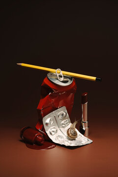 Lipstick, a metal can with a pencil and blister pack with a snail on
