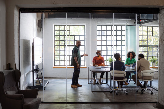 Business Team Meeting in Modern Glass Conference Room