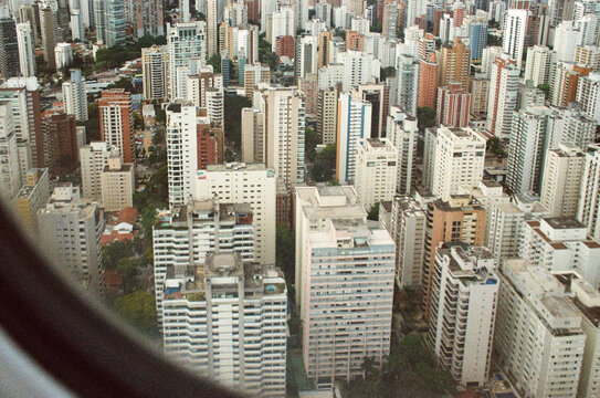 Towering residential blocks seen through aircraft window