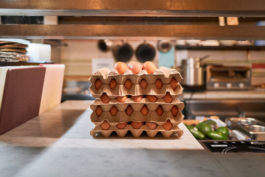Egg Cartons Stacked on a Kitchen Counter