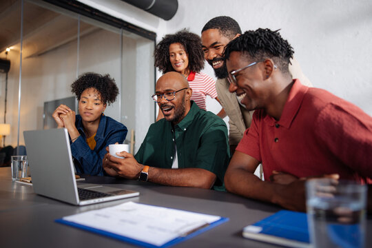 Team Smiling During Casual Office Meeting
