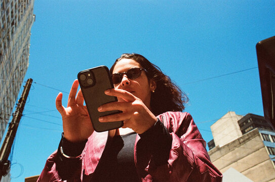 Person using smartphone on latin american city street