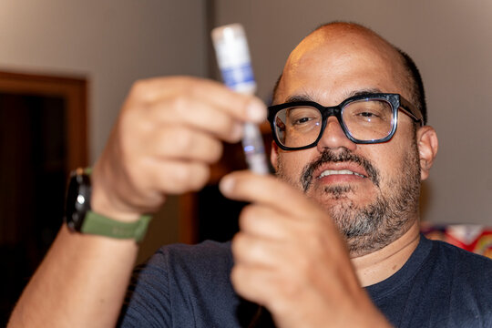 Adult preparing medication vial for self-treatment