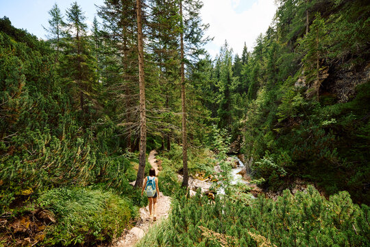 Woman hikes near Cascate di Fanes in the Dolomites. Italy