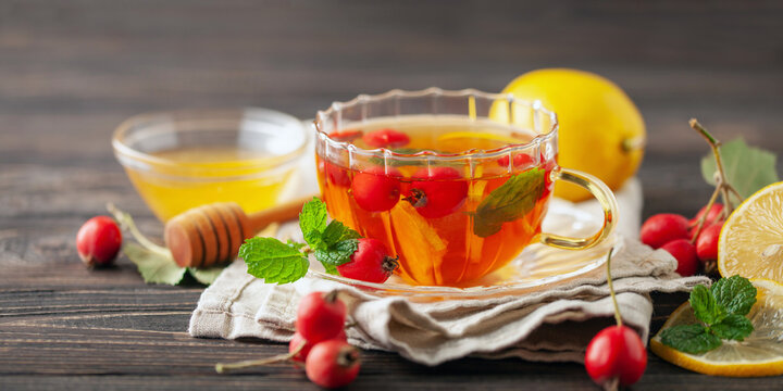 Hawthorn tea with mint leaves, honey and lemon in a glass  cup on the table. Vitamin health drink.