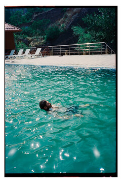 Enjoying a swim in a clear pool on a sunny day