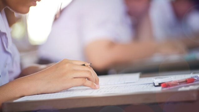 The students were doing the exams inside the classroom with stress.Assessment examination of high school students