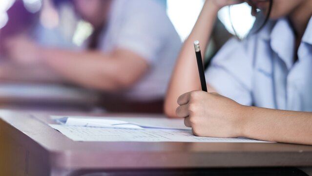 Assessment examination of high school students dressed in uniform.The students were doing the exams inside the classroom with stress