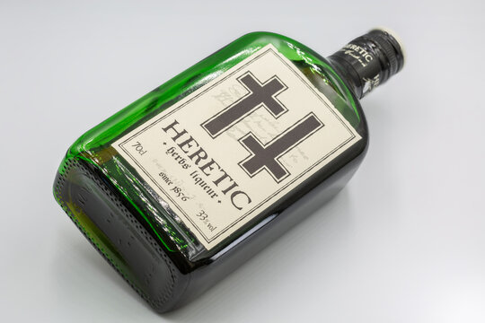 Heretic spirits liqueur green bottle closeup on white.
