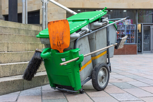 Street cleaner hand truck with bins, brooms and shovel, city cen
