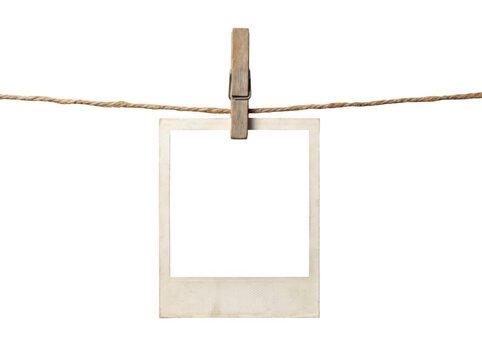 Blank vintage photo frame hanging on a clothesline as isolated on with as isolated on transparent background