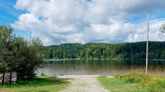 South bank of Kirchsee lake in Upper Bavaria lake in the middle of Ellbach-Kirchseemoor nature reserve, accessible at the end of a hiking trail from Kloster Reutberg Monastery