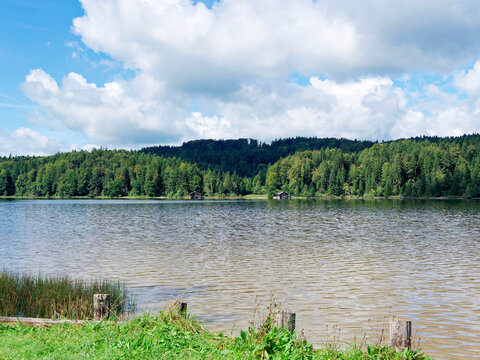 Lake Kirchsee in Sachsenkam, within the Ellbach-Kirchseemoor nature reserve. View of the see rescue station, small beach, and wooden walkways for bathers