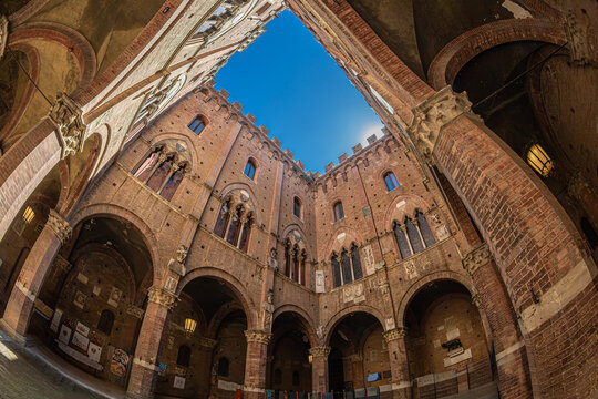 Siena, Tuscany, Italy &ndash; May 23, 2026: The inner courtyard of the Palazzo Pubblico (the city hall), with medieval Gothic architecture. Build in 1297 to house the government of the republic.