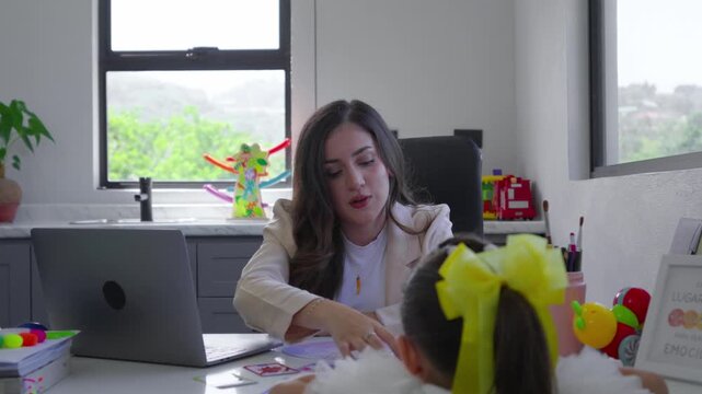 Child psychologist using emotion flashcards during therapy session with a little girl