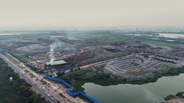 Wide establishing view of a garbage collection and waste recycling land aerial waste management