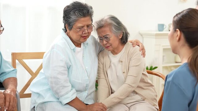 An elderly woman shares a warm, supportive moment with a friend while a healthcare professional assists at home. Friendship, companionship, senior care, emotional support, aging, healthcare.