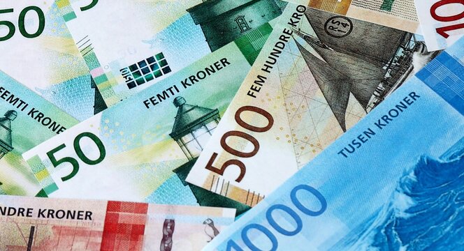 Norwegian krone money bills in pile on table. Norway NOK currency cash close up