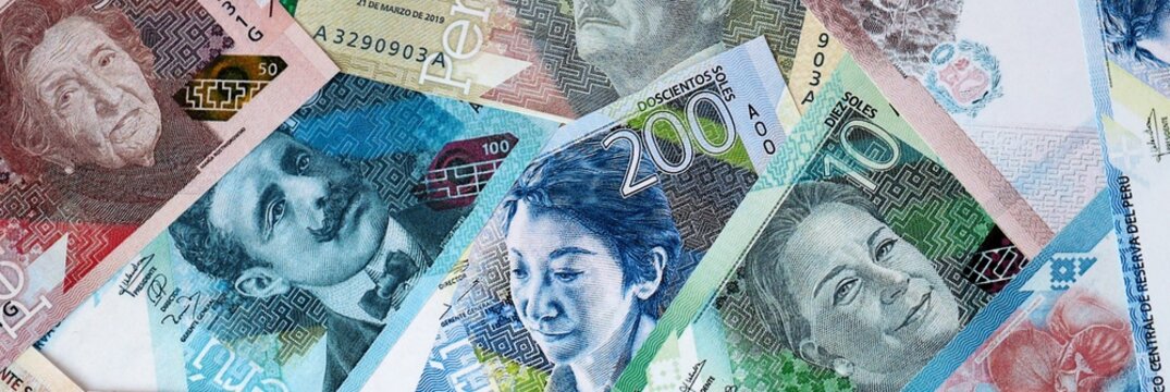 Peruvian sol money bills in pile on table. Peru PEN currency cash close up