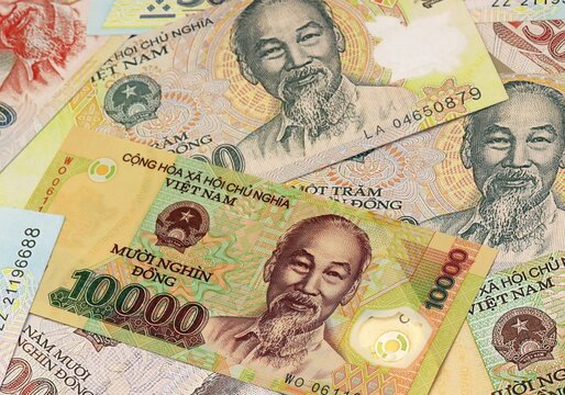 Vietnamese dong money bills in pile on table. Vietnam VND currency cash close up