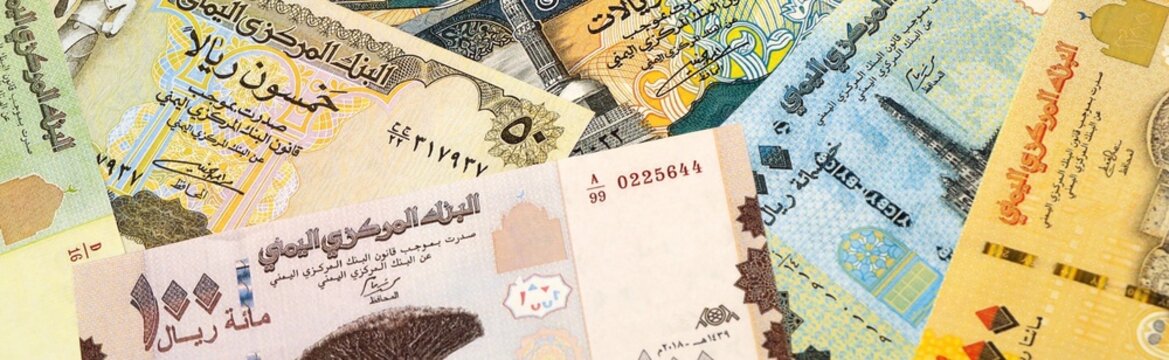 Yemeni rial money bills in pile on table. Yemen YER currency cash close up