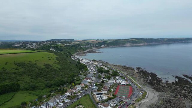 High Angle Footage of Beach and Ocean at Looe Town of England During Hot Sunny Day. Looe is a coastal town and civil parish in southeast Cornwall, England, United Kingdom.
