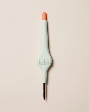 White handheld thermometer probe with a brushed steel tip and orange cap, featuring a smooth satin finish for weather and climate change explainers