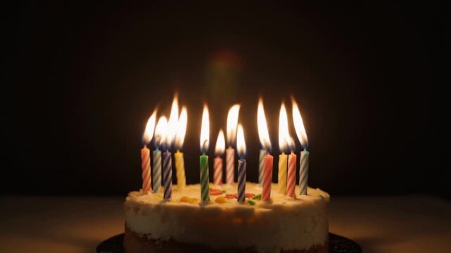 Birthday candles flickering on a cake