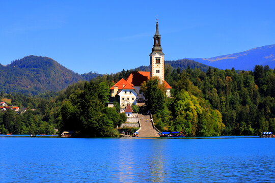 Lake Bled, Slovenia: Scenic view of the Assumption of Mary Church on the island with Bled Castle on a cliff and mountains