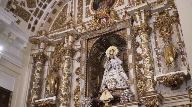 Ornate golden altarpiece and interior dome in spanish catholic church