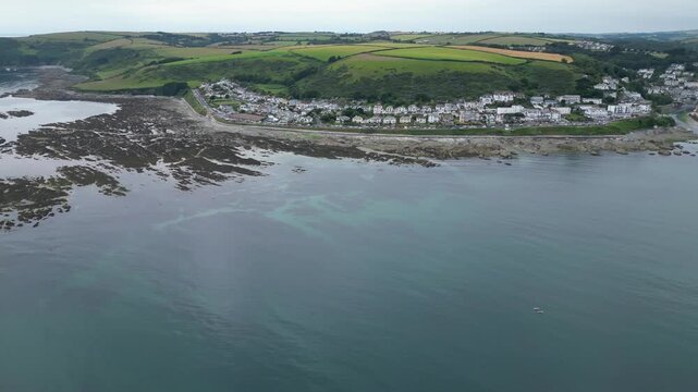 High Angle Footage of Beach and Ocean at Looe Town of England During Hot Sunny Day. Looe is a coastal town and civil parish in southeast Cornwall, England, United Kingdom.