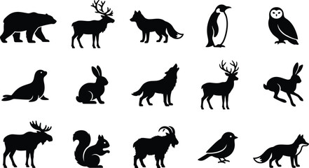 Obraz premium A collection of silhouetted winter animals bears deer foxes penguins owls and more in a snowy scene
