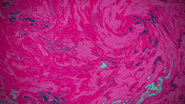 Vibrant pink and cyan paint swirls moving in fluid animation footage