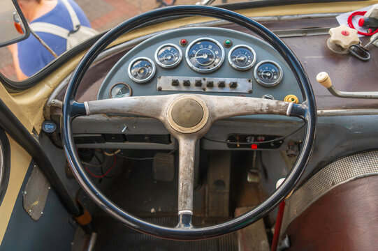 Vintage bus dashboard with old steering wheel and analog gauges