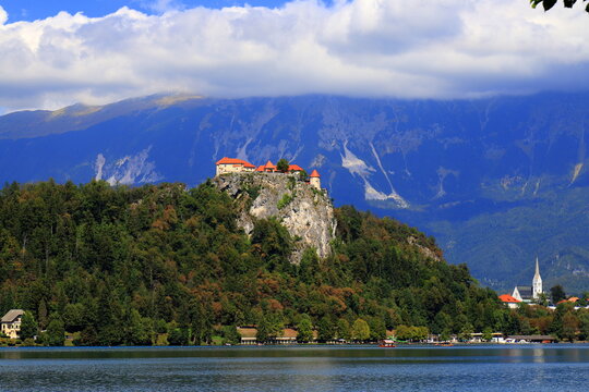 Lake Bled, Slovenia: Beautiful view of the old castle on a high rock near the lake. Beautiful blue mountains