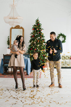 Family Enjoying Christmas Celebration With Golden Confetti
