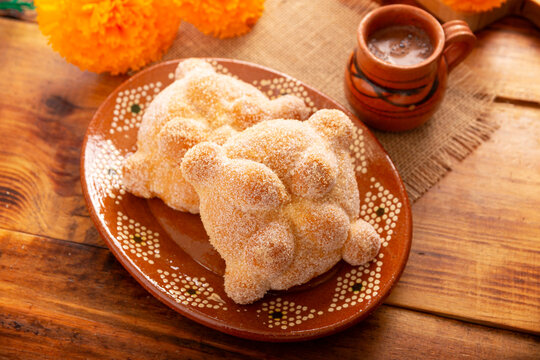 Pan de Muerto. Traditional Mexican sweet bread that is consumed in the season of the day of the dead. It is a main element in the altars and offerings in the Dia de Muertos celebration.