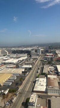 Aerial view of busy highway in Los Angeles near airport and cityscape from high plane landing at the airport