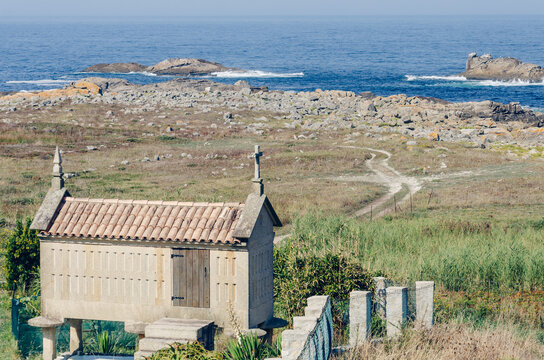 Traditional stone horreo granary on a elevated coastal field overlooking the ocean