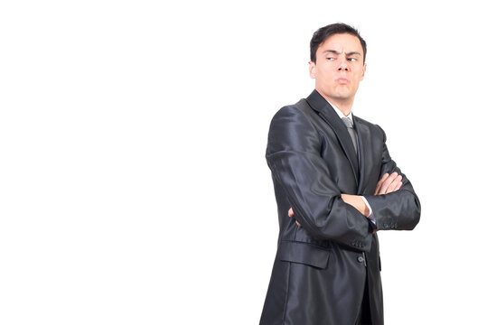 Side view of attentive young male with dark hair in formal outfit looking away with suspicion