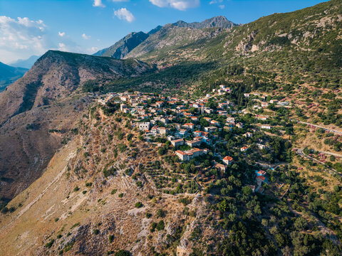 Drone view of small Albanian village built on rocky hillside, real Mediterranean landscape and rural lifestyle illustration in QEPARO FUSHE, ALBANIA