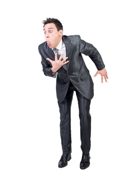 Full body of young male entrepreneur in classy suit with dark hair making grimace and vomit gesture